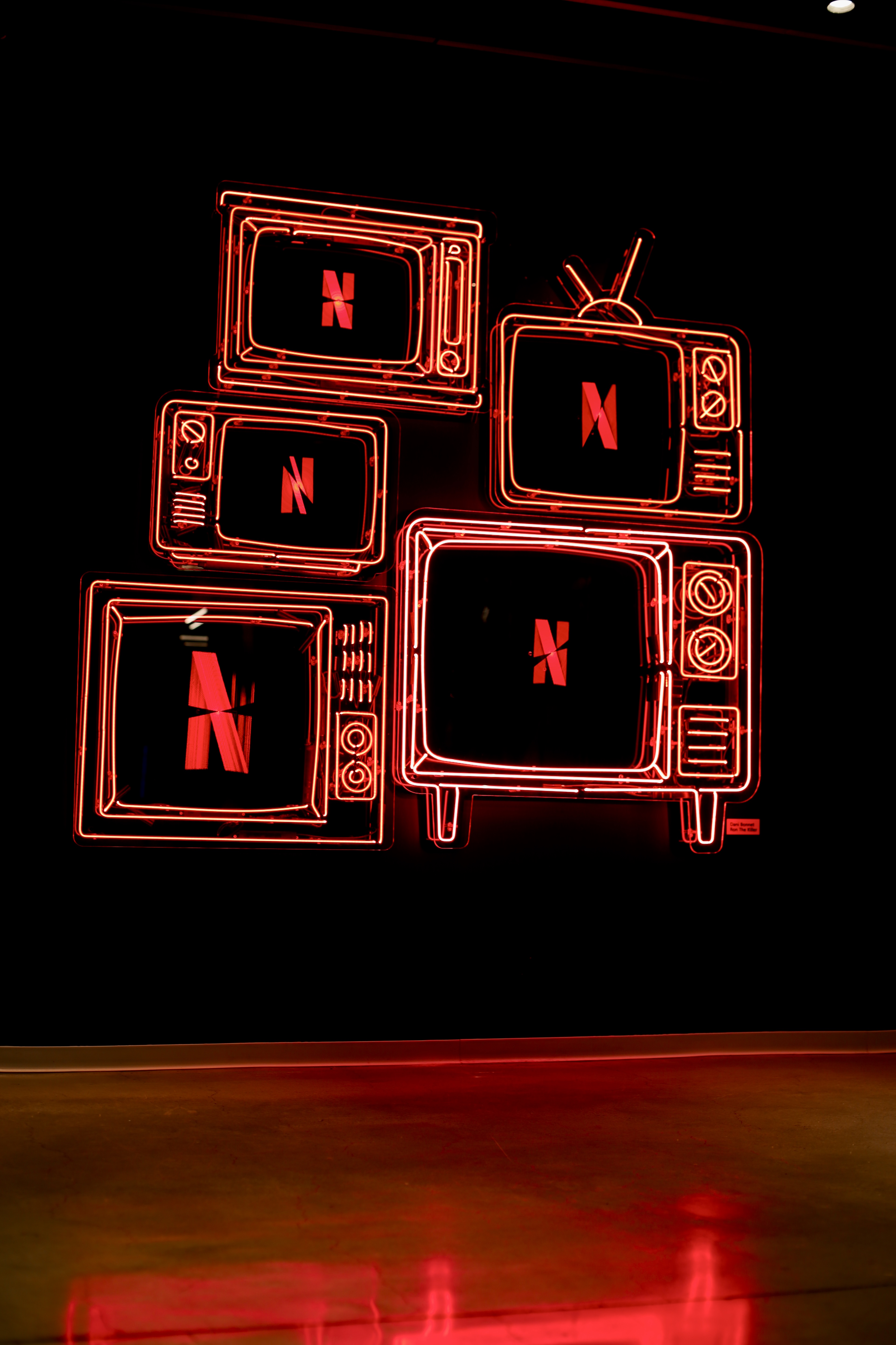 5 bright red neon analog televisions featuring a spinning led hologram inside.